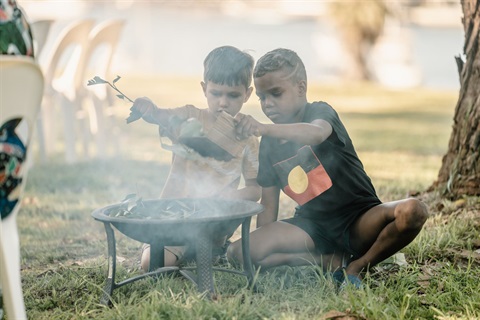Indigenous children at campfire