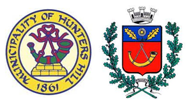 Image shows the HUNTERS HILL COUNCIL coat of arms along side the Le Vesinet Coat of Arms. Demonstrates how similar our coat of arms are, specifically by the presence of the Hunting Horn.