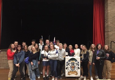 Photo shows the full group of exchange students standing within the Hunters Hill Town Hall. There are 23 students in total.