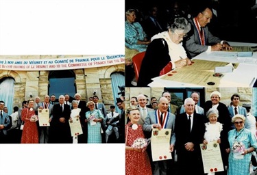 Image is a set of three photos, showing scenes from the signing of the Friendship Pact in 1988. The left most photo shows the representatives of both towns, surrounded by supporters. The upmost photo is of the undersigned parties signing the documents. The bottom photo is a close up of the first image on the steps of Town Hall.