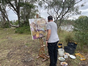 Artist-painting-the-views-at-Lart-de-la-Terre-en-plein-air.jpg