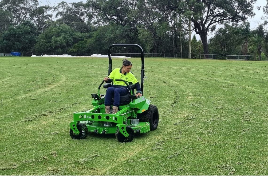 Outside worker trialing new electric mower at Riverglade Reserve