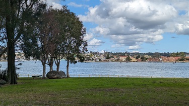 Photo shows the reserve grounds, with the water in the background, as well as the nearby islands and suburbs.