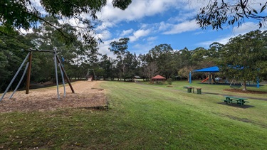 Buffalo Creek reserve playground and flying fox, as well as showing sheltered gazebos as well as public bins and tables