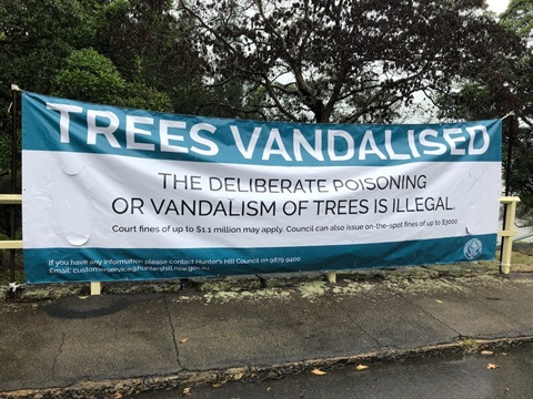 Large vinyl street banner advising of tree vandalism and penalties that apply