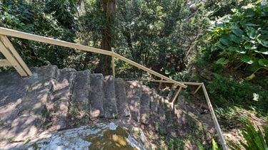 Stone steps leading further down into the reserve, photo is a high angle so that the drop-off is clearly visible